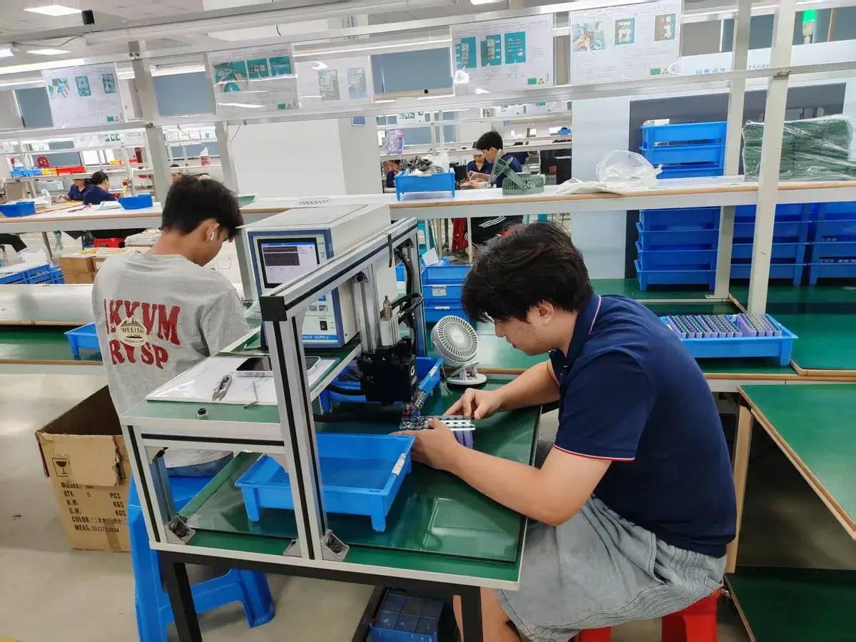 Workers assembling battery packs at a manufacturing partner facility
